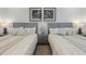 Close up of two beds in a bedroom with matching decor and lamps at 1015 Jack Nicklaus Ct, Kissimmee, FL 34747