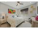 Bedroom featuring a queen bed, ceiling fan, and colorful wall art at 1015 Jack Nicklaus Ct, Kissimmee, FL 34747