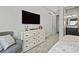Bedroom with a large TV, comfortable seating and ensuite bathroom access at 1015 Jack Nicklaus Ct, Kissimmee, FL 34747