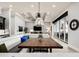Bright dining area features a wooden table, comfortable seating, and views of the living area and outdoor patio at 1015 Jack Nicklaus Ct, Kissimmee, FL 34747