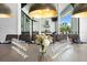 Elegant dining room featuring a long table set for a formal meal, with views of the outdoor kitchen at 1015 Jack Nicklaus Ct, Kissimmee, FL 34747