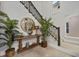 Foyer with a decor table, mirror, plants, stairway and large format tile floors at 1015 Jack Nicklaus Ct, Kissimmee, FL 34747
