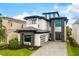 Elegant home featuring stone accents, a driveway and garage, and lush landscaping at 1015 Jack Nicklaus Ct, Kissimmee, FL 34747