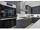 Modern kitchen with dark cabinets, stainless steel appliances, and white subway tile backsplash at 1015 Jack Nicklaus Ct, Kissimmee, FL 34747