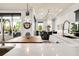 Modern kitchen features a long wooden table with white marble counter tops, large sink, and ample lighting at 1015 Jack Nicklaus Ct, Kissimmee, FL 34747