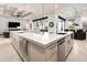 Large island with white countertops and stainless appliances in open kitchen at 1015 Jack Nicklaus Ct, Kissimmee, FL 34747