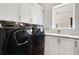 Functional laundry room featuring modern appliances, ample storage, and a convenient utility sink at 1015 Jack Nicklaus Ct, Kissimmee, FL 34747