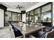 A covered patio showing an outdoor dining table with seating and sliding glass doors at 1015 Jack Nicklaus Ct, Kissimmee, FL 34747