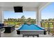 Entertainer's outdoor patio space offering comfortable seating, a pool table, and a great view at 1015 Jack Nicklaus Ct, Kissimmee, FL 34747