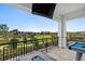 Relaxing outdoor patio area featuring comfortable seating, a pool table, and beautiful landscaping at 1015 Jack Nicklaus Ct, Kissimmee, FL 34747