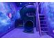 Playroom with slide and space-themed mural for a fun and immersive experience at 1015 Jack Nicklaus Ct, Kissimmee, FL 34747