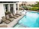 A luxurious swimming pool features multiple lounge chairs and nearby recreation area at 1015 Jack Nicklaus Ct, Kissimmee, FL 34747