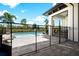 Beautiful pool with a -safety fence, lounge chairs, and covered patio at 1015 Jack Nicklaus Ct, Kissimmee, FL 34747