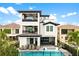 Home exterior showcases pool, lounging space, and balconies for luxury outdoor living at 1015 Jack Nicklaus Ct, Kissimmee, FL 34747