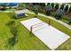 Overhead shot showcasing a sand volleyball court alongside a shaded picnic area and community green space at 1015 Jack Nicklaus Ct, Kissimmee, FL 34747