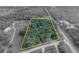 Aerial view outlining property boundaries on a wooded lot with a home and outbuildings at 1050 Bob White Trl, Chuluota, FL 32766