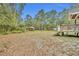 Expansive backyard with mature trees, green grass and structures at 1050 Bob White Trl, Chuluota, FL 32766