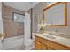 Bathroom with tiled shower, framed mirror, and vanity with a sink at 1050 Bob White Trl, Chuluota, FL 32766