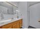 Bathroom features a wooden vanity, and a shower with a white shower curtain at 1050 Bob White Trl, Chuluota, FL 32766