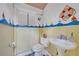 Nautical themed bathroom with sailboat decor and pedestal sink at 1050 Bob White Trl, Chuluota, FL 32766