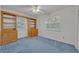 Bedroom featuring built-in shelves, two windows, and blue carpeted floors at 1050 Bob White Trl, Chuluota, FL 32766