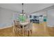 Dining area with hardwood floors, pendant lighting, and seamless flow to the kitchen at 1050 Bob White Trl, Chuluota, FL 32766