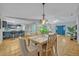 Open-concept dining area connecting to a modern kitchen and a bright living space at 1050 Bob White Trl, Chuluota, FL 32766