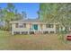 Charming single story home with a blue front door and shuttered windows at 1050 Bob White Trl, Chuluota, FL 32766