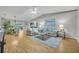 Bright living room featuring hardwood floors, cozy furniture, and natural light at 1050 Bob White Trl, Chuluota, FL 32766