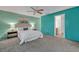 Bright main bedroom featuring a ceiling fan, plush carpet, and an attached bathroom at 1050 Bob White Trl, Chuluota, FL 32766