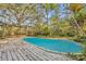 Backyard pool with wood deck and lush, mature landscaping creating a private oasis at 1050 Bob White Trl, Chuluota, FL 32766