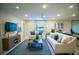 Living room with blue accents and comfortable sofas at 110 Rosedale Dr, Deltona, FL 32738