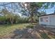 Spacious backyard featuring mature trees providing ample shade and privacy at 1113 Leeward Dr, Deltona, FL 32738