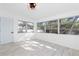 Bright bedroom featuring large windows, a modern ceiling fan and gray-toned flooring at 1113 Leeward Dr, Deltona, FL 32738