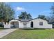 Charming home featuring unique architecture, an arched entry, and a well-maintained front yard at 1113 Leeward Dr, Deltona, FL 32738