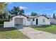 Charming home with unique architecture, a driveway, and a well-maintained front yard at 1113 Leeward Dr, Deltona, FL 32738