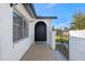 Inviting arched front door with textured walls, tiled walkway, and decorative iron gate at 1113 Leeward Dr, Deltona, FL 32738