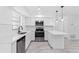 Bright, renovated kitchen featuring stainless steel appliances, white cabinets, and a large island with quartz countertop at 1113 Leeward Dr, Deltona, FL 32738
