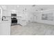 Bright kitchen with stainless steel appliances, white cabinets, and open to a spacious room at 1113 Leeward Dr, Deltona, FL 32738
