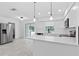 Bright kitchen featuring white countertops and cabinets, stainless appliances, and tile floors at 1113 Leeward Dr, Deltona, FL 32738