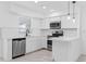 Clean kitchen featuring white cabinets, stainless steel appliances, and tile floors at 1113 Leeward Dr, Deltona, FL 32738