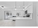 Bright kitchen featuring white cabinets, stainless steel appliances, and tile floors at 1113 Leeward Dr, Deltona, FL 32738