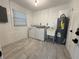Bright laundry room features modern washer, dryer, and utility sink at 1113 Leeward Dr, Deltona, FL 32738