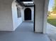 Charming covered front porch with beautiful arched entry and tiled flooring at 1113 Leeward Dr, Deltona, FL 32738