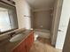 Bathroom featuring granite countertops, cherry cabinetry, and neutral tile flooring at 11574 Westwood Blvd # 1122, Orlando, FL 32821