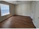Empty bedroom featuring laminate flooring, large windows, and neutral paint at 11574 Westwood Blvd # 1122, Orlando, FL 32821