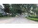 Gated entrance into community surrounded by mature trees and landscaping at 11574 Westwood Blvd # 1122, Orlando, FL 32821