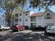 Exterior view of condominium complex with visible parking and manicured greenery at 11574 Westwood Blvd # 1122, Orlando, FL 32821