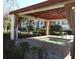 Outdoor hot tub with covered pergola and landscaping in a community area at 11574 Westwood Blvd # 1122, Orlando, FL 32821