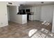 Bright, open-concept living room with a view of the kitchen and sliding glass doors at 11574 Westwood Blvd # 1122, Orlando, FL 32821